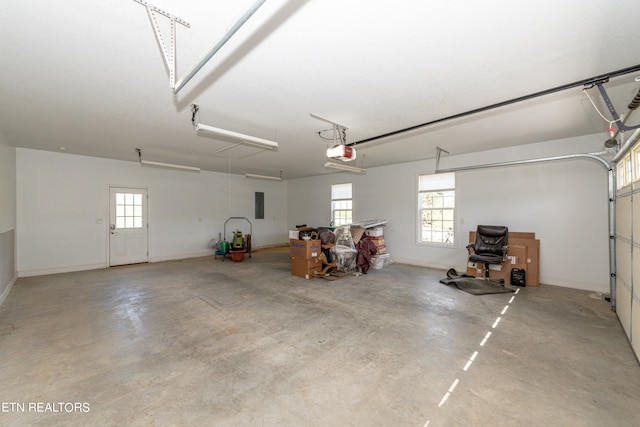 garage featuring electric panel and a garage door opener