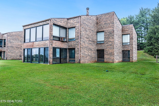 rear view of house featuring a lawn