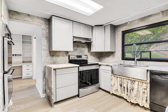 kitchen with gray cabinets, light hardwood / wood-style floors, sink, and stainless steel appliances