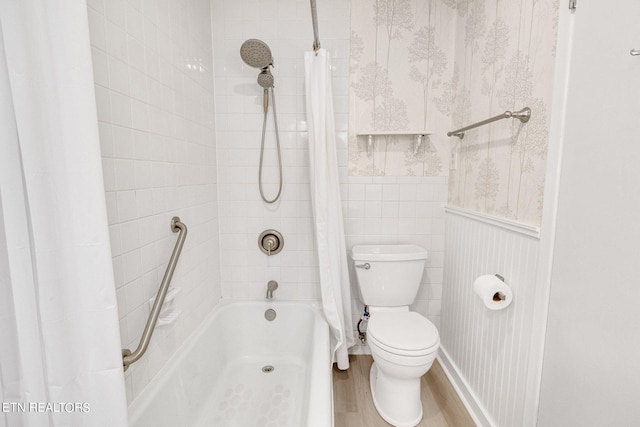 bathroom with hardwood / wood-style flooring, toilet, and shower / bath combination with curtain