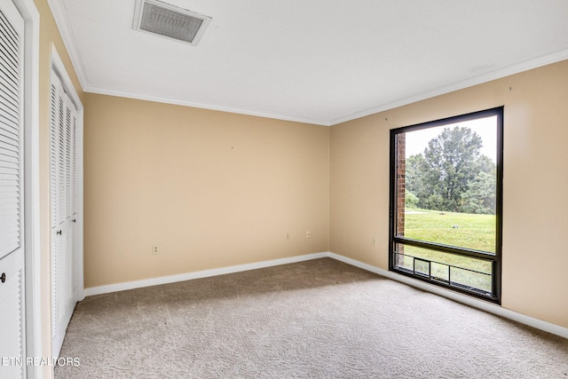 unfurnished bedroom with ornamental molding and carpet