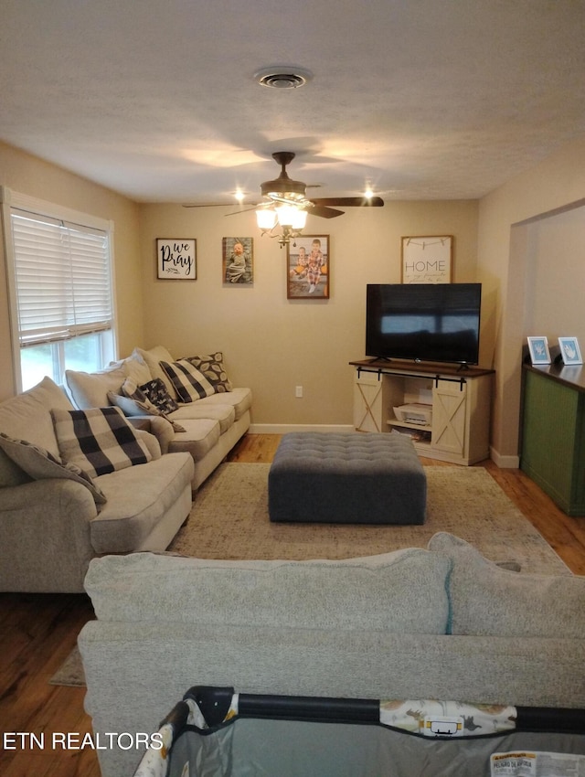 living room with ceiling fan and hardwood / wood-style floors