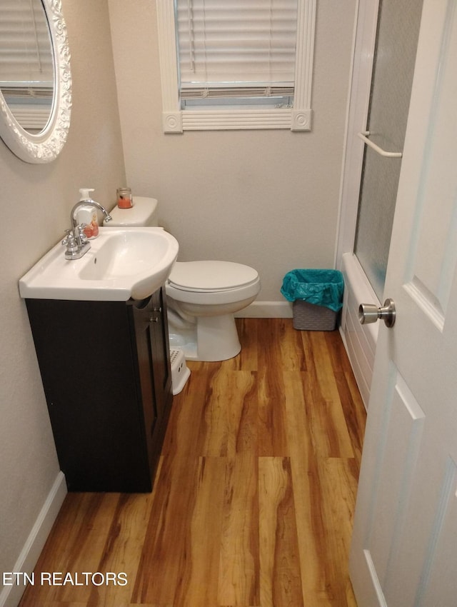 bathroom featuring hardwood / wood-style flooring, vanity, and toilet