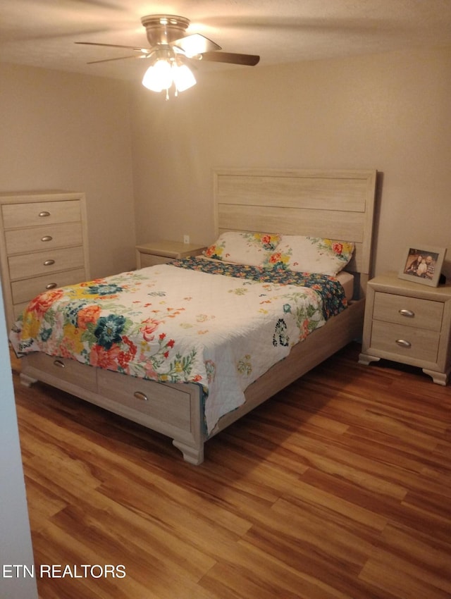 bedroom with hardwood / wood-style floors and ceiling fan