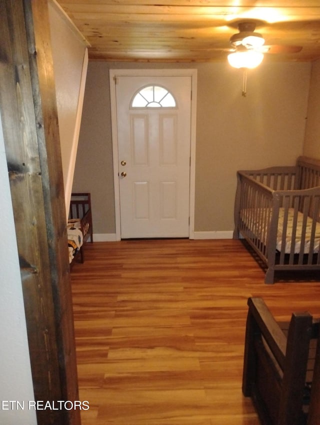 foyer entrance with wood-type flooring and wood ceiling