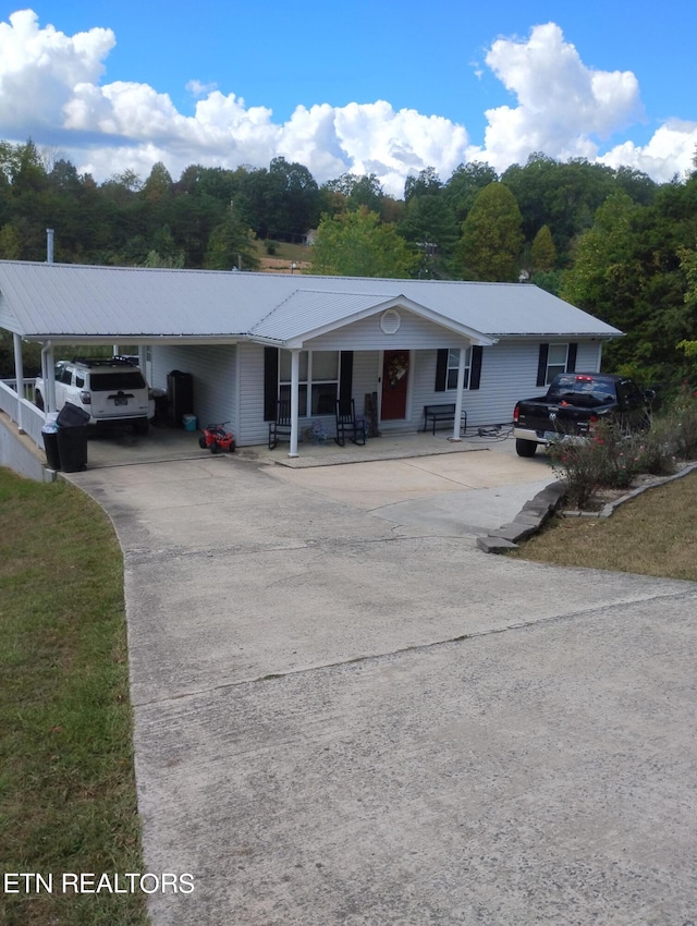 ranch-style home featuring a carport