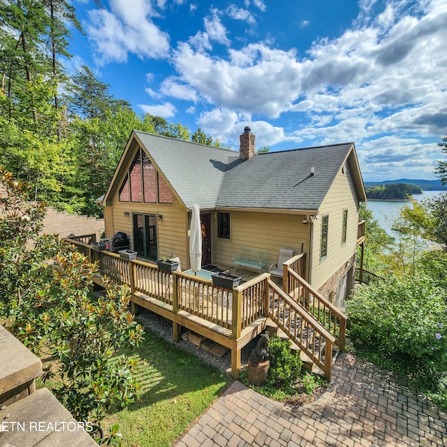 back of house with a deck with water view