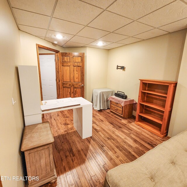 office featuring hardwood / wood-style flooring and a paneled ceiling