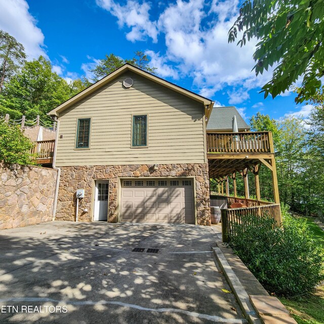 view of home's exterior with a deck and a garage