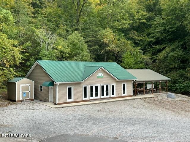 view of front of property featuring an outbuilding and a carport