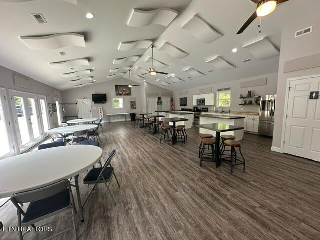 dining room with a wealth of natural light, lofted ceiling, and ceiling fan