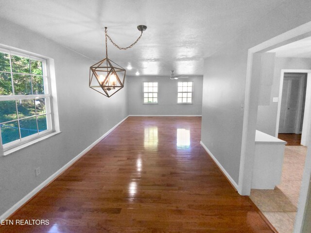 interior space with a notable chandelier, dark hardwood / wood-style floors, and a wealth of natural light