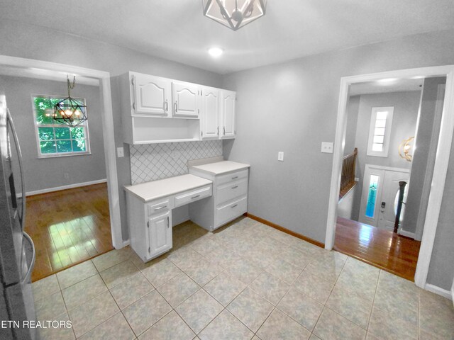 kitchen featuring a healthy amount of sunlight, light hardwood / wood-style flooring, and white cabinets