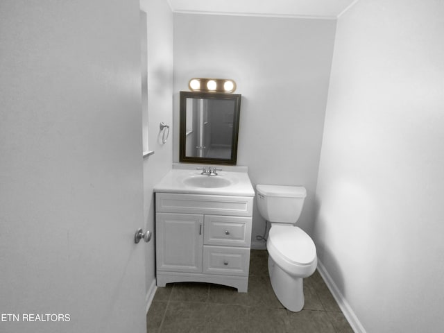 bathroom with tile patterned flooring, vanity, and toilet