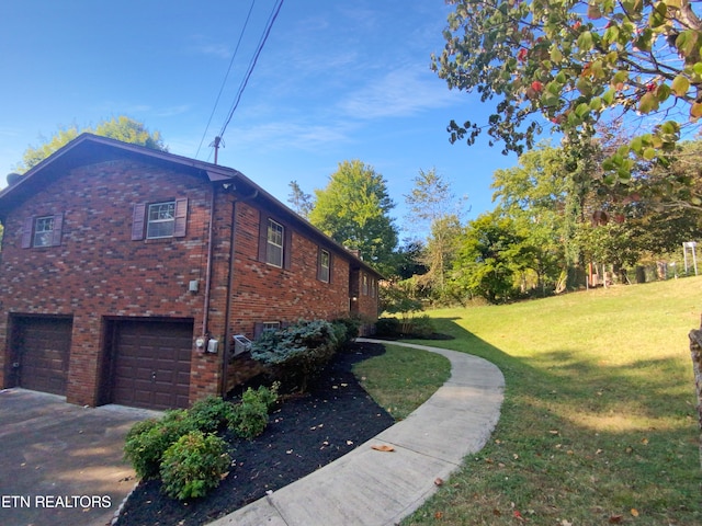 view of side of property with a garage and a yard