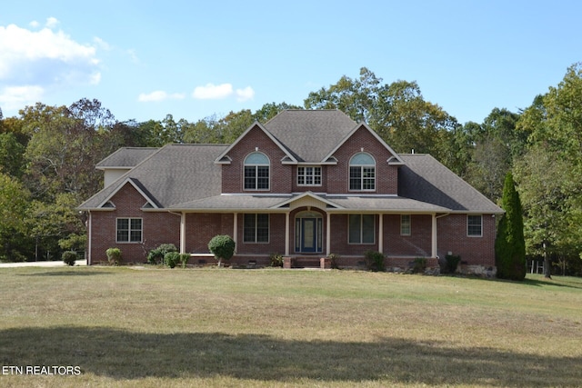 view of front of home featuring a front yard and covered porch