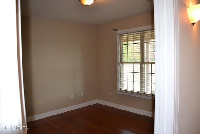 spare room with dark wood-type flooring