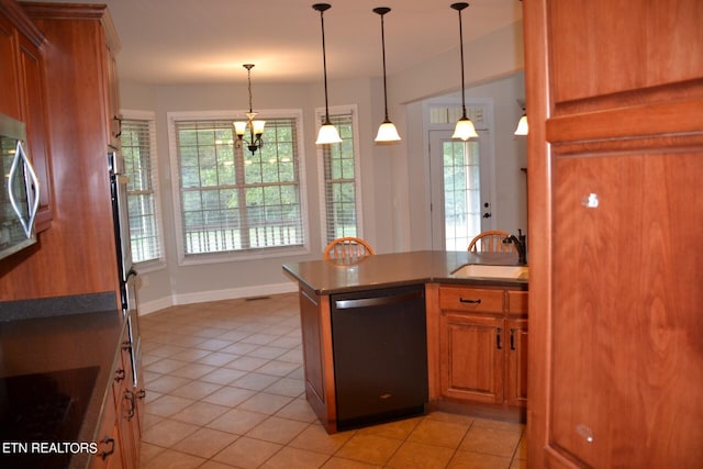 kitchen featuring pendant lighting, plenty of natural light, sink, and stainless steel dishwasher