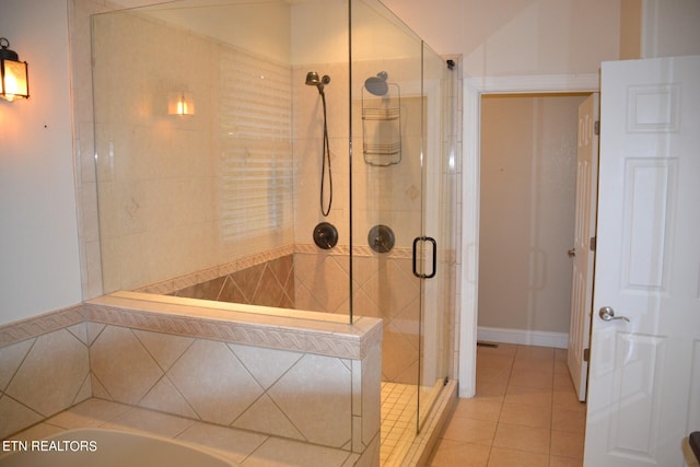 bathroom featuring lofted ceiling, tile patterned flooring, and independent shower and bath