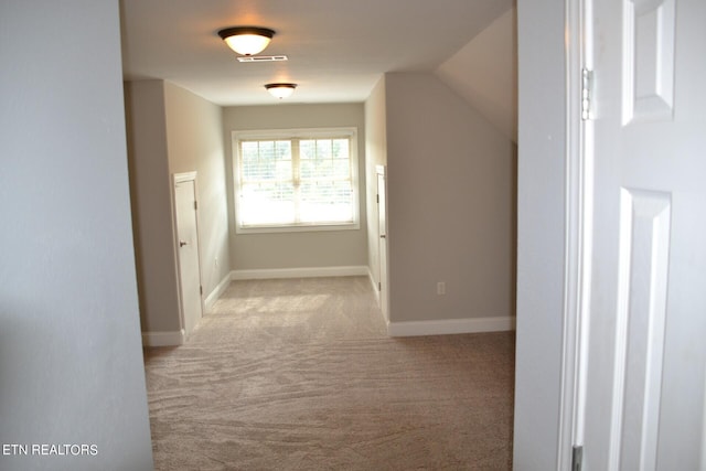 bonus room featuring light colored carpet and lofted ceiling