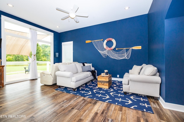 living room featuring ceiling fan and wood-type flooring