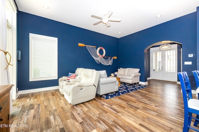 living room with wood-type flooring and ceiling fan