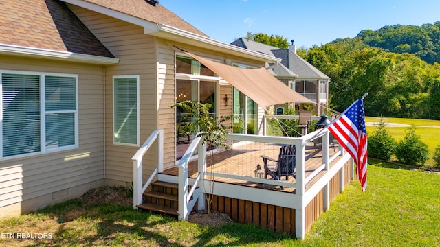 back of house with a wooden deck and a yard