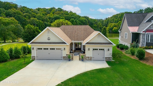 view of front of home featuring a garage and a front yard