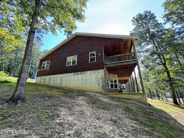 view of side of property with a balcony