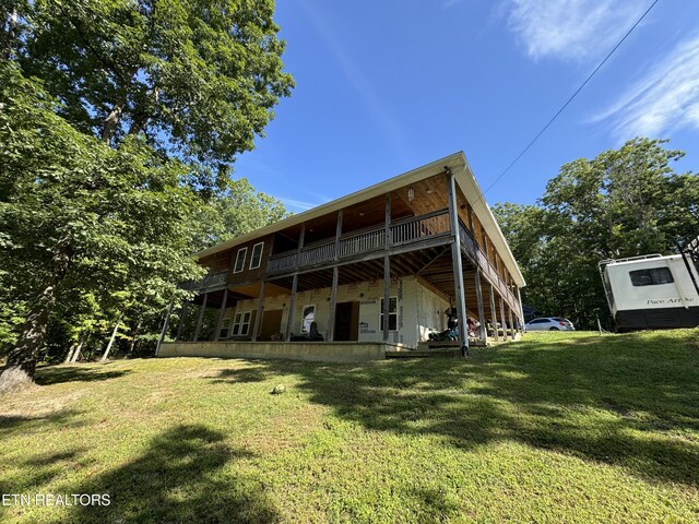 back of property featuring a lawn