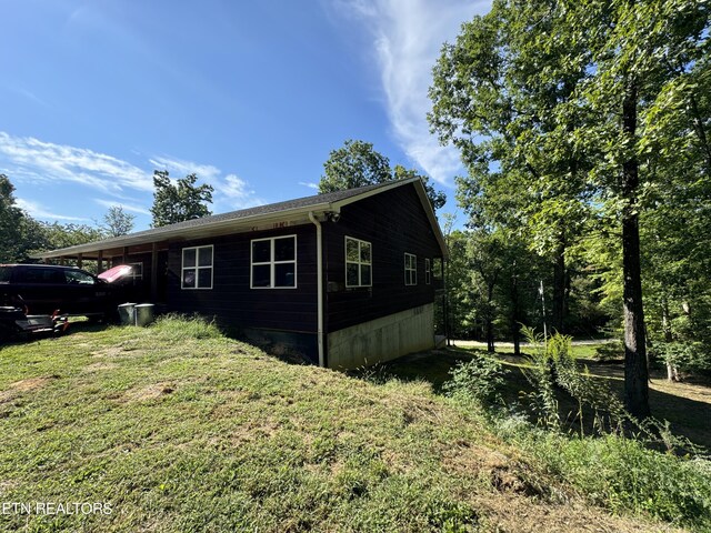 view of home's exterior with a yard