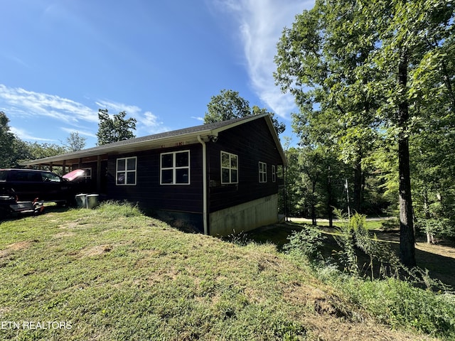 view of property exterior with a lawn
