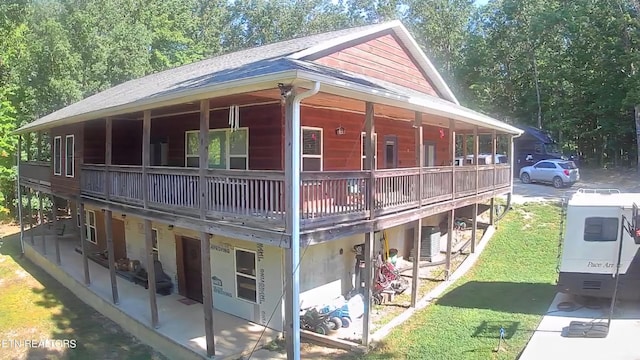 view of property exterior featuring central AC unit, a yard, and roof with shingles