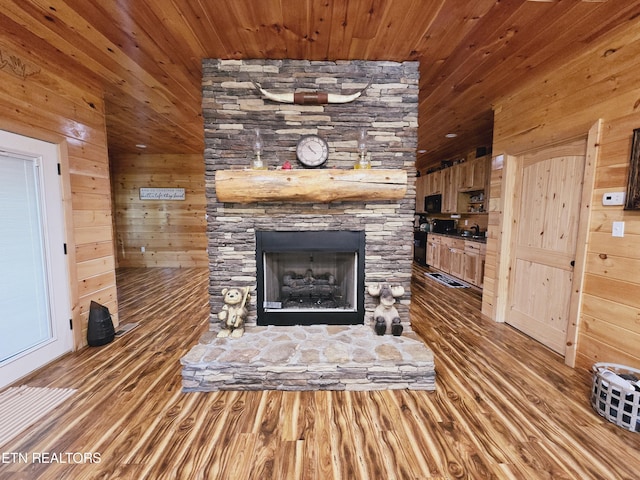 room details featuring a fireplace, wood finished floors, wood walls, and wood ceiling