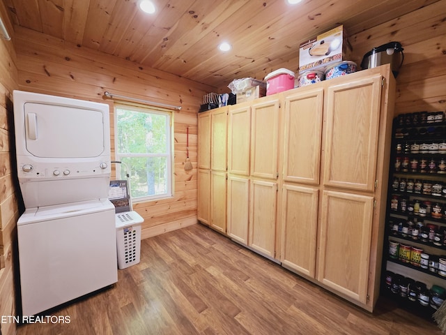 laundry room with wood walls, recessed lighting, wood ceiling, stacked washer / dryer, and light wood-style flooring