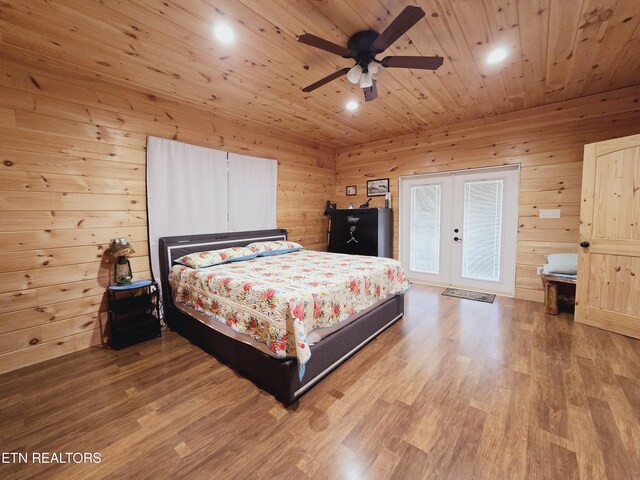 bedroom featuring wood ceiling, ceiling fan, french doors, hardwood / wood-style flooring, and wooden walls