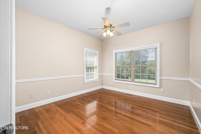 unfurnished room with a wealth of natural light, ceiling fan, and hardwood / wood-style floors