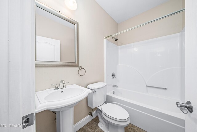 bathroom featuring shower / washtub combination, tile patterned floors, and toilet