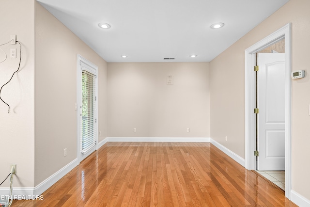 spare room featuring wood-type flooring