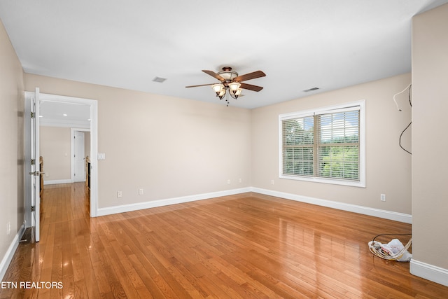 unfurnished room featuring ceiling fan and hardwood / wood-style floors