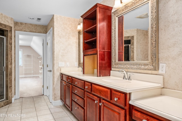 bathroom with vanity, lofted ceiling, and tile patterned floors