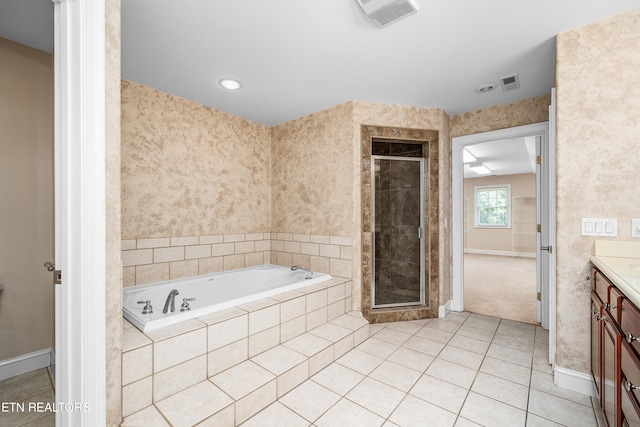 bathroom featuring independent shower and bath, vanity, and tile patterned floors