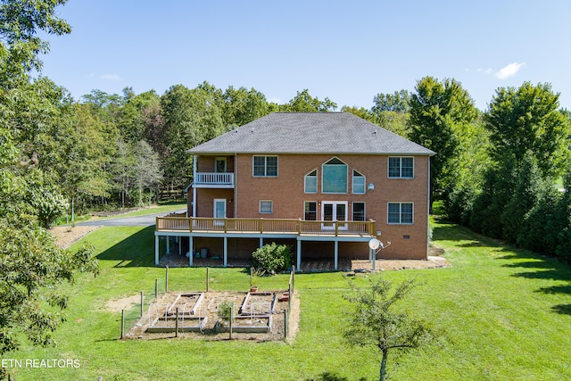 back of property featuring a balcony and a lawn