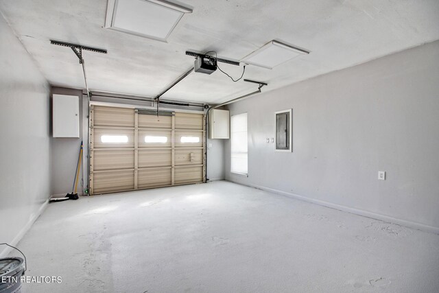 garage with electric panel and a garage door opener