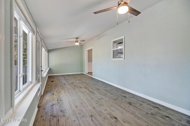 empty room with hardwood / wood-style floors and ceiling fan