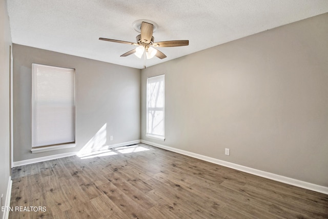 spare room with ceiling fan, a textured ceiling, and hardwood / wood-style floors