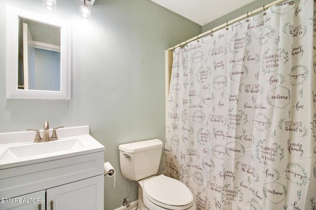 bathroom with vanity, toilet, and a shower with shower curtain