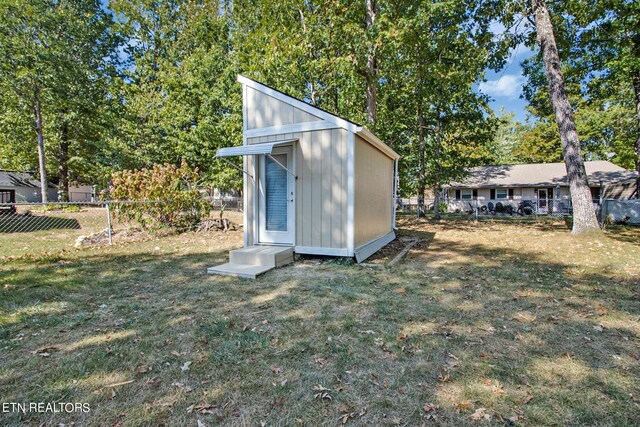 view of outdoor structure with a lawn