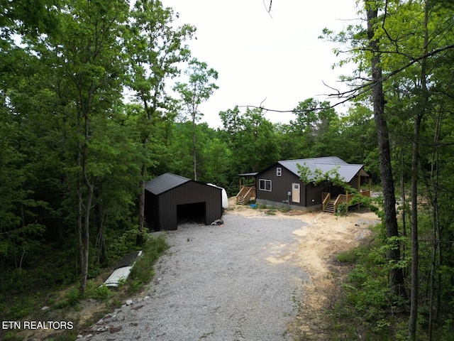 view of front facade featuring an outbuilding and a garage