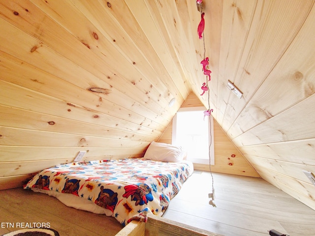 bedroom featuring wooden walls, wooden ceiling, wood-type flooring, and vaulted ceiling